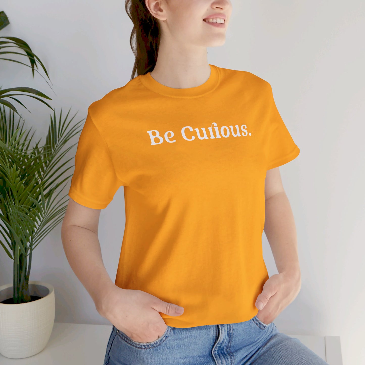 Be Curious simple w/ Lighthouse International on back Unisex Jersey Short Sleeve Tee