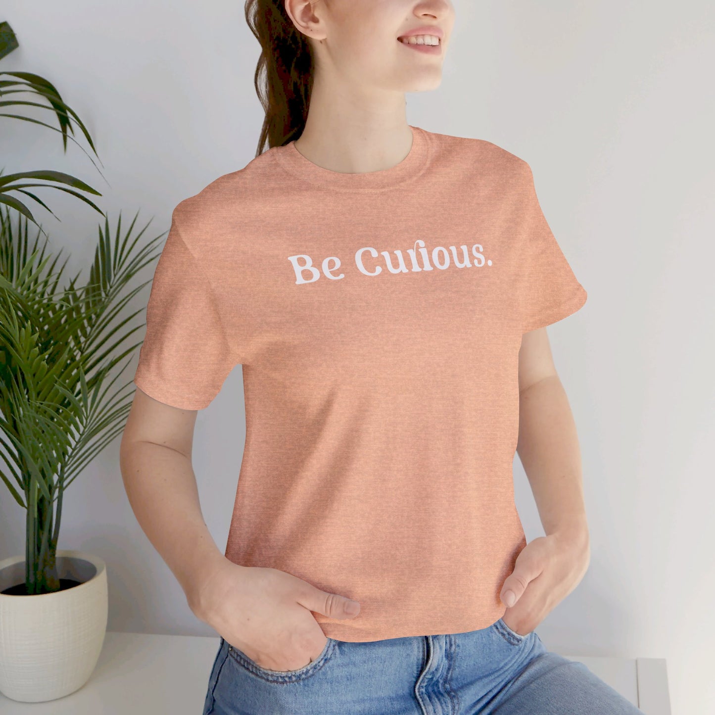 Be Curious simple w/ Lighthouse International on back Unisex Jersey Short Sleeve Tee