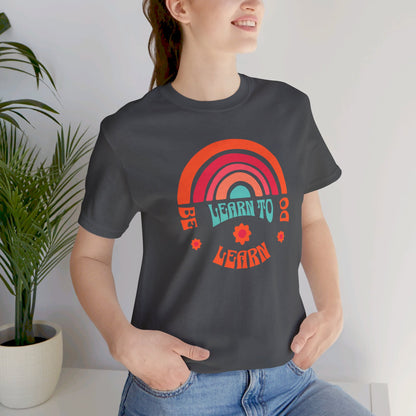 Learn to Be Rainbow Unisex Jersey Short Sleeve Tee